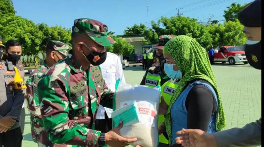 Komandan Kodim 0811 Letkol Infantri Villiala Romadon saat menyerahkan bantuan beras dan masker ke perwakilan masyarakat di Makodim 0811 Tuban. (Foto: Rochim/Tugu Jatim)