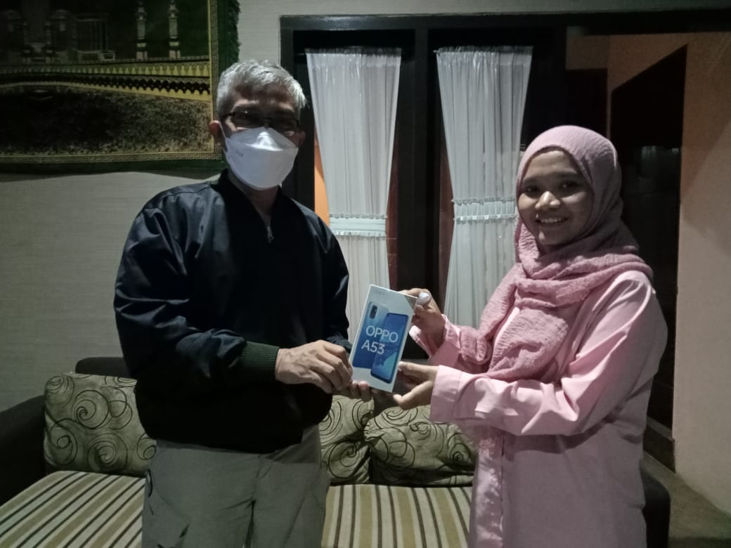 Pemimpin Redaksi Tugu Jatim ID, Nucrholis MA Basyari bersama pemenang undian smartphone, Mila Arinda. (Foto: Dokumen)