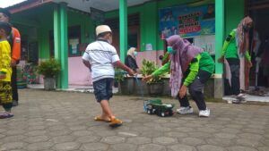 Tampak anak pengungsian bersama pendamping ketika bermain mobil untuk mengurangi rasa trauma. (Foto: Noe/Tugu Jatim)