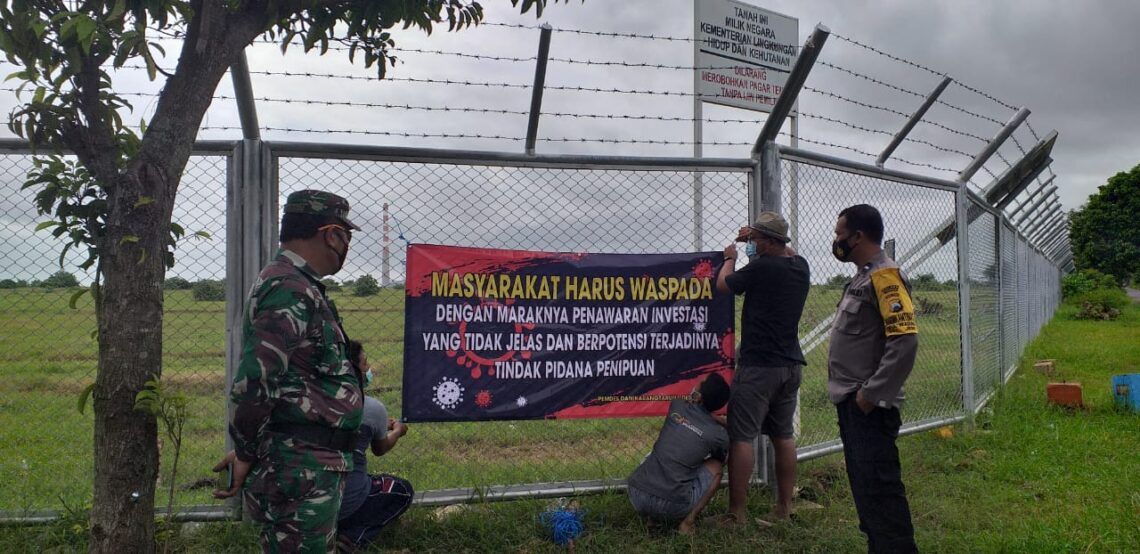 Sejumlah warga di Kecamatan Jenu, Kabupaten Tuban tampak bersama-sama memasang banner atau spanduk yang melarang sales-marketing masuk wilayah desa mereka. (Foto: Moch Abdurrochim)