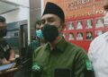 Sekretaris LTN NU PCNU Kabupaten Malang Zulham Mubarok saat melakukan pengaduan dan pelaporan di Mapolres Malang pada Senin (08/03/2021). (Foto:Rap/Tugu Jatim)
