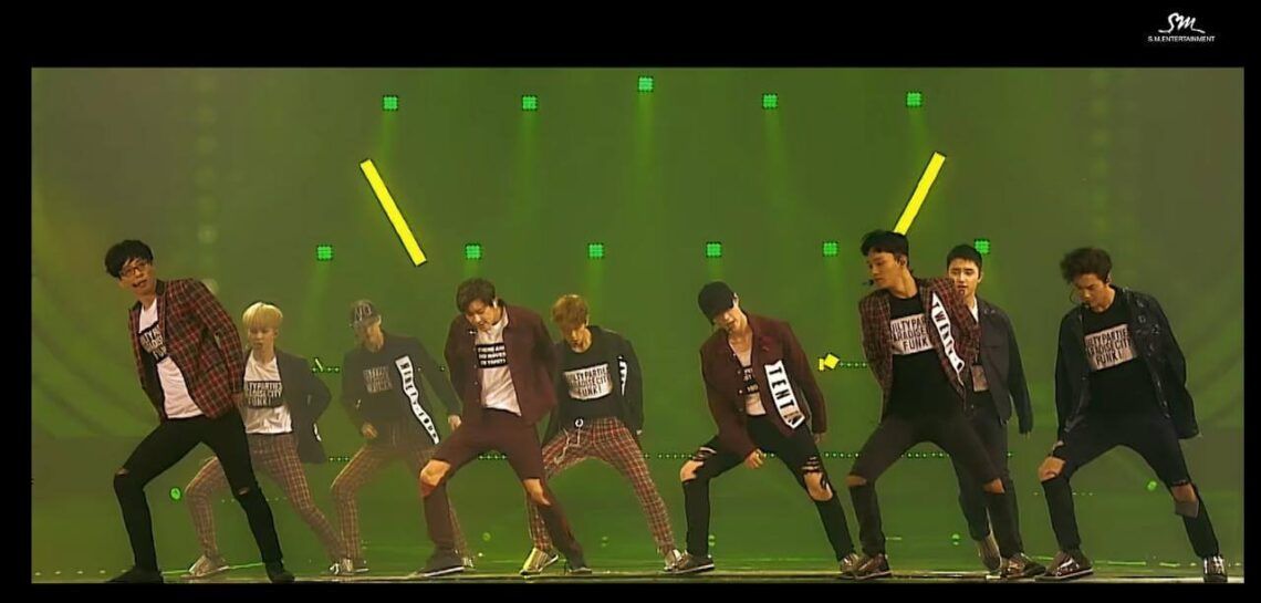 EXO dan Yoo Jae Suk dalam musik video single kolaborasi “Dancing King” 2016 lalu. (Foto: YouTube/SMTOWN)