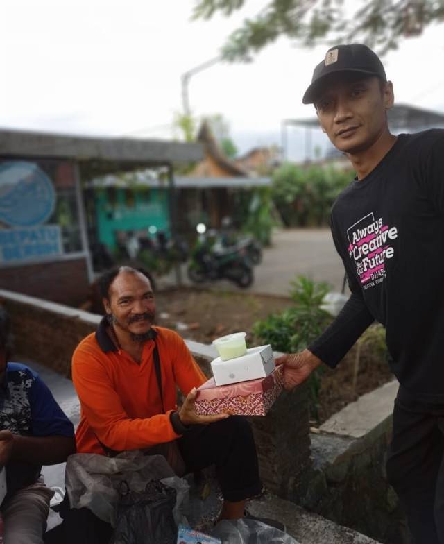 Salah satu difabel bernama Dila memberikan menu buka puasa kepada warga. (Foto: Tugu Media Group/Tugu Jatim)