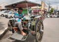 Suprapto duduk di delmannya sambil menunggu penumpang di Alun-Alun Batu. (Foto: Sholeh/Tugu Jatim)