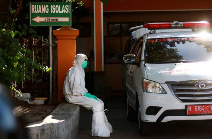 Salah satu petugas PSC 119 Dinkes Kota Malang yang tampak siaga di depan mobil ambulans. (Foto: Rubianto/Tugu Jatim)