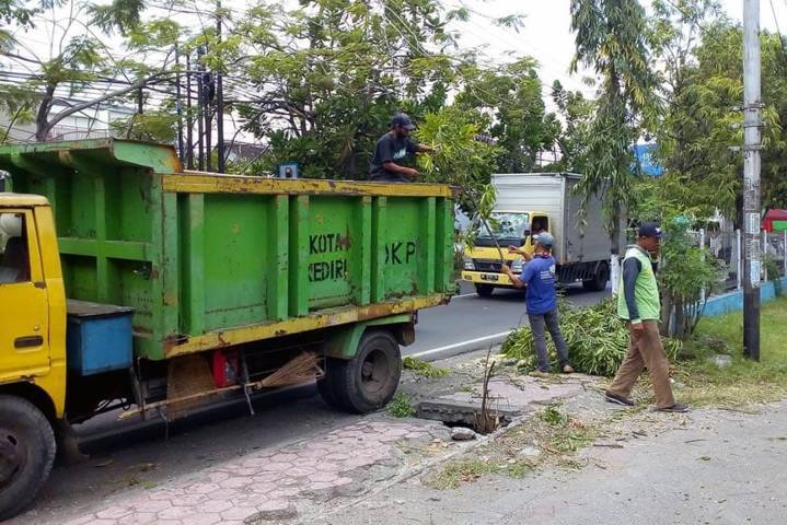 Petugas di Kota Kediri tampak membersihkan pohon tumbang agar masyarakat terhindar dari bahaya. (Foto: Dokumen/Tugu Jatim)