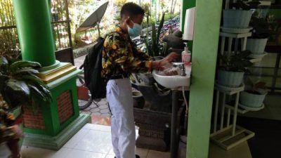 Salah satu siswa SMPN 1 Bojonegoro saat mencuci tangan sebelum memasuki gedung sekolah pada Kamis (02/09/2021). (Foto: Mila Arinda/Tugu Jatim)