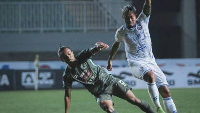 Pemain Arema FC, Kushedya Ari Yudo (jersey putih) sedang berduel dengan pemain PSS Sleman Samsul Arifin (hijau) pada laga lanjutan Liga 1 di Stadion Pakansari, Bogor, Minggu (19/9/2021). (Foto: Instagram/Arema FC Official) tugu jatim