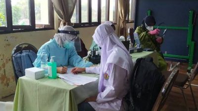 Salah seorang siswi madrasah di Kota Batu menjalani pemeriksaan sebelum vaksinasi, Selasa (14/9/2021). (Foto: M Ulul Azmy/Tugu Malang/Tugu Jatim)