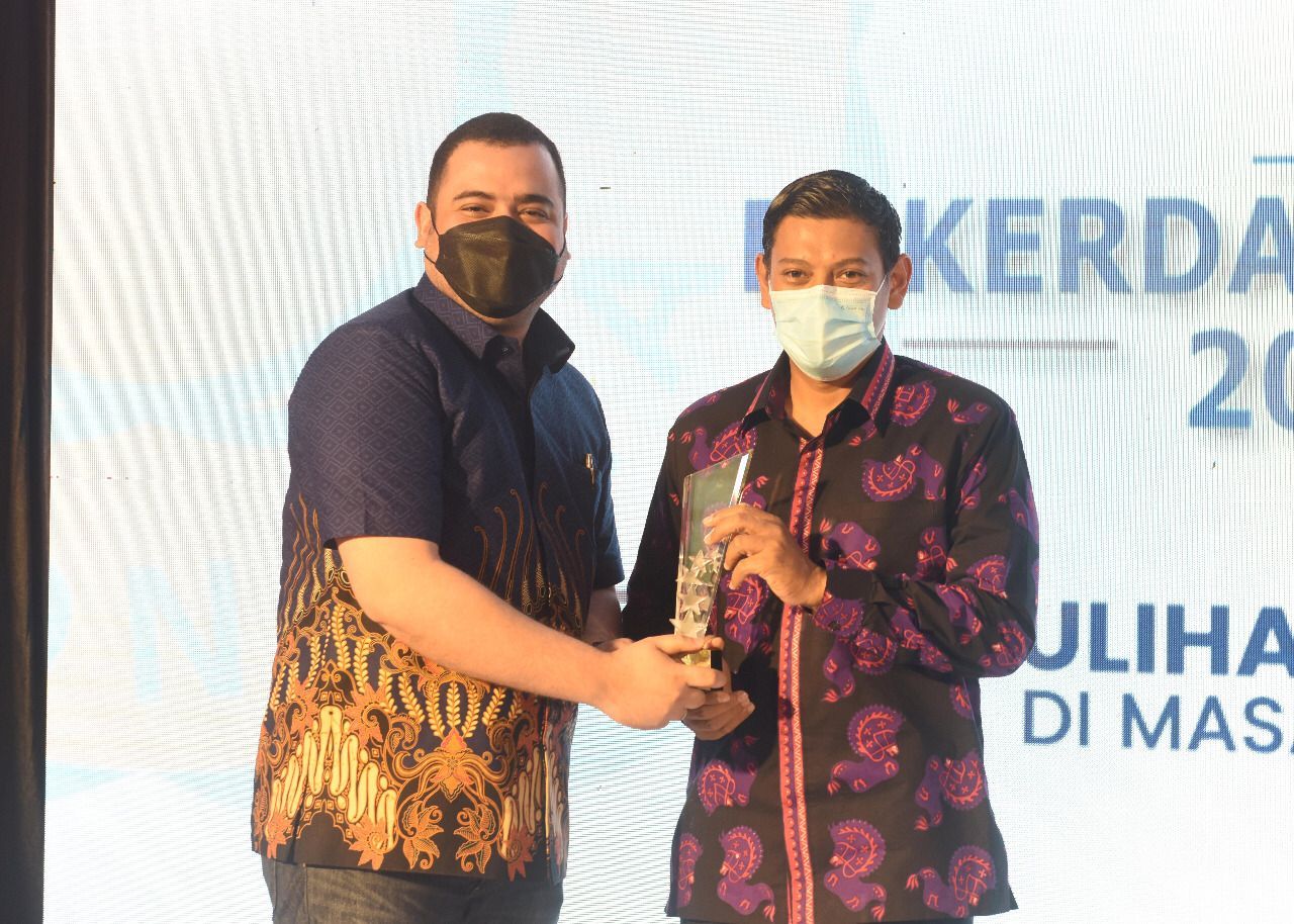 Wali Kota Kediri Abdullah Abu Bakar menerima penghargaan dalam kategori Karmika Graha Abinaya dari Wakil Ketua Bidang Organisasi dan Profesionalisme Keanggotaan DPD REI Jatim DPD Real Estat Indonesia (REI) Jawa Timur Ahmad Salim di Grand Surya, Selasa (12/10/2021). (Foto: Dokumen/Tugu Jatim)