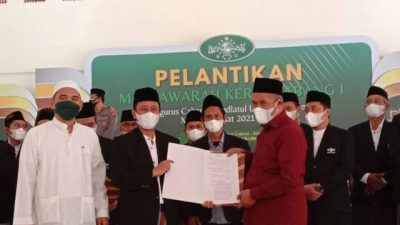 Ketua PWNU Jatim KH Marzuki Mustamar memberikan SK pelantikan Pengurus PCNU 2021-2026 kepada ketua PCNU KH Abu Bakar Abdul Jalil, di Aula Muktamar Ponpes Lirboyo, Kota Kediri. (Foto" Rino Hayyu Setyo/Tugu Jatim)