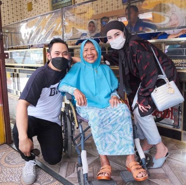 Pasangan Crazy Rich Malang, Gilang Widya Pramana dan Shandy Purnamasari saat mengunjungi ibu Trimah yang ditelantarkan 3 anaknya di panti jompo, Griya Lansia Husnul Khotimah, Minggu (31/10/2021). (Foto: Instagram/juragan_99) tugu jatim