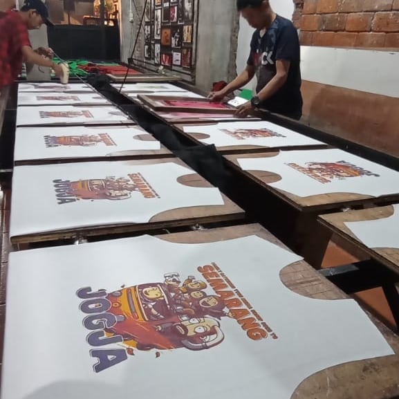 Proses pembuatan kaos liburan Tugu Media Group.