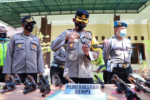 Wakapolres Kediri, Kompol Ibnu Henry, melakukan pemeriksaan kondisi senjata api milik anggotanya.