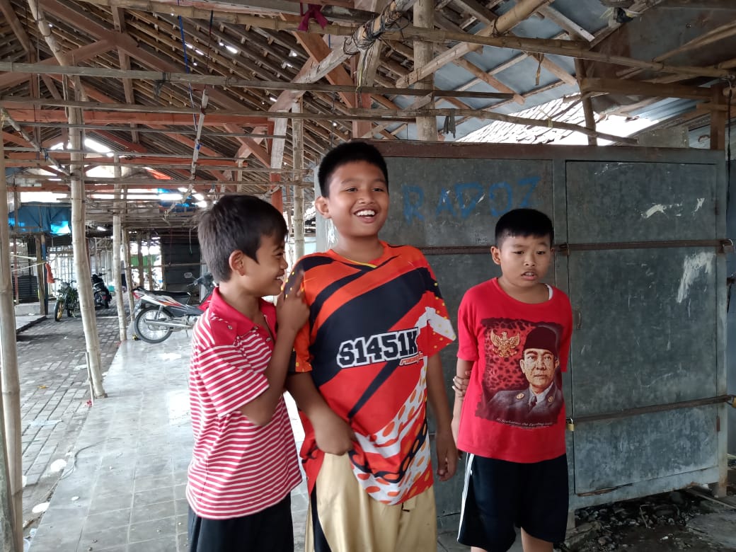 Jepan (8) (tengah) bersama kedua rekannya, saksi kebakaran Pasar Bungkal Desa Sidobandung, Kecamatan Balen, Kabupaten Bojonegoro, Rabu (22/06/2022).