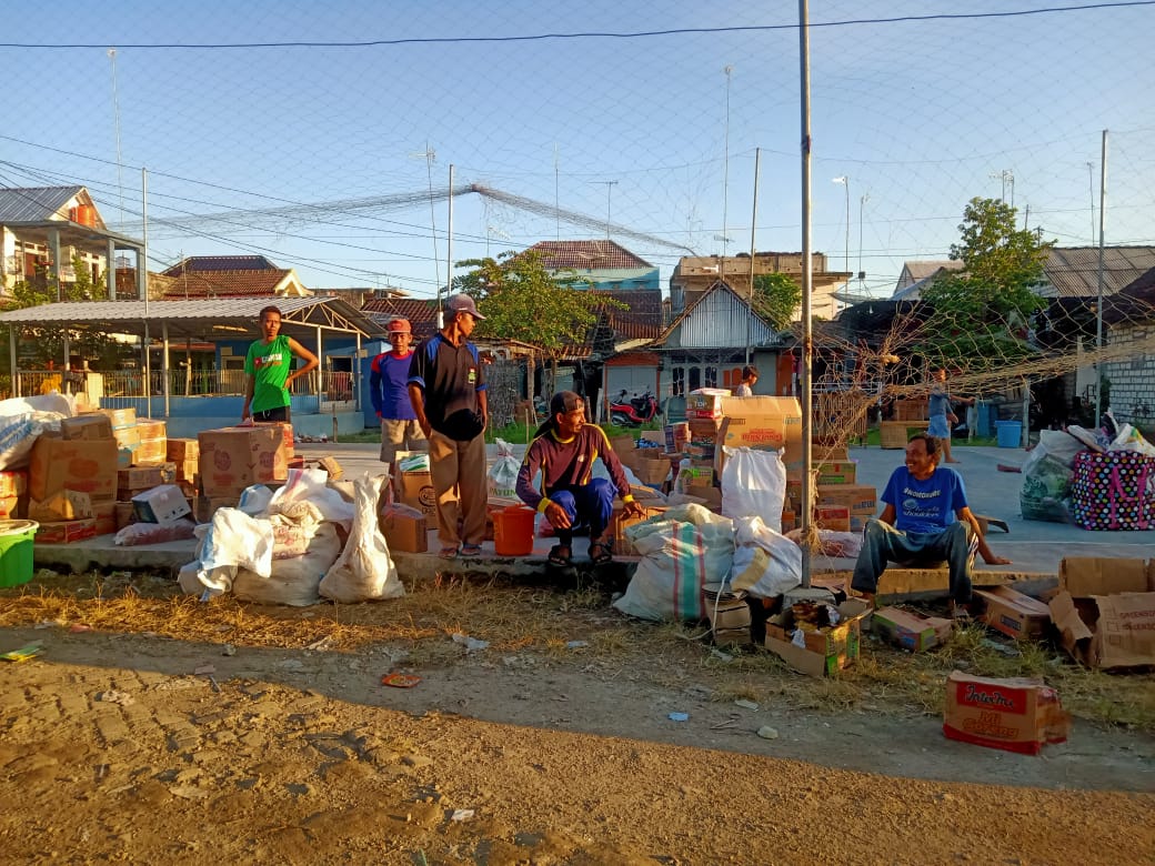 Pemilik kios duduk di sebelah barang-barang yang masih bisa diselamatkan dalam peristiwa Kebakaran di Pasar Bungkal, Desa Sidobandung, Kecamatan Balen, Kabupaten Bojonegoro, Rabu (22/06/2022).
