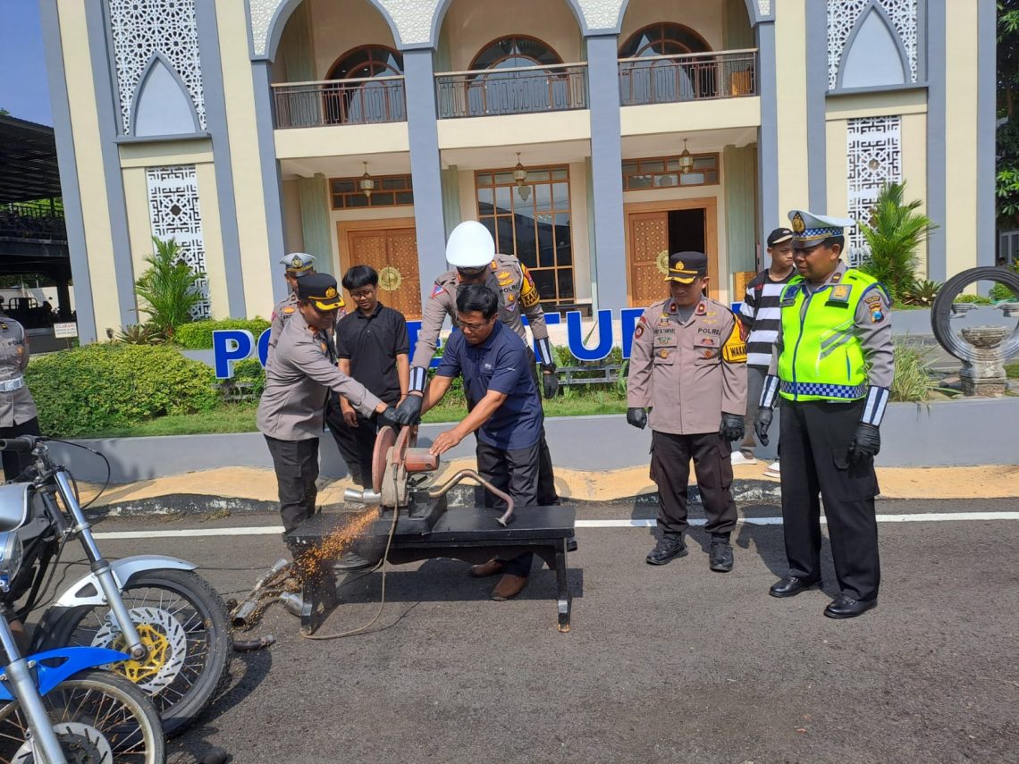 Kapolres Tuban, AKBP Suryono didampingi Kasat Lantas Polres Tuban, AKP Ayip Rizal dan orang tua pelanggar lalu lintas memusnahkan knalpot brong. Foto: Rochim/Tugu Jatim