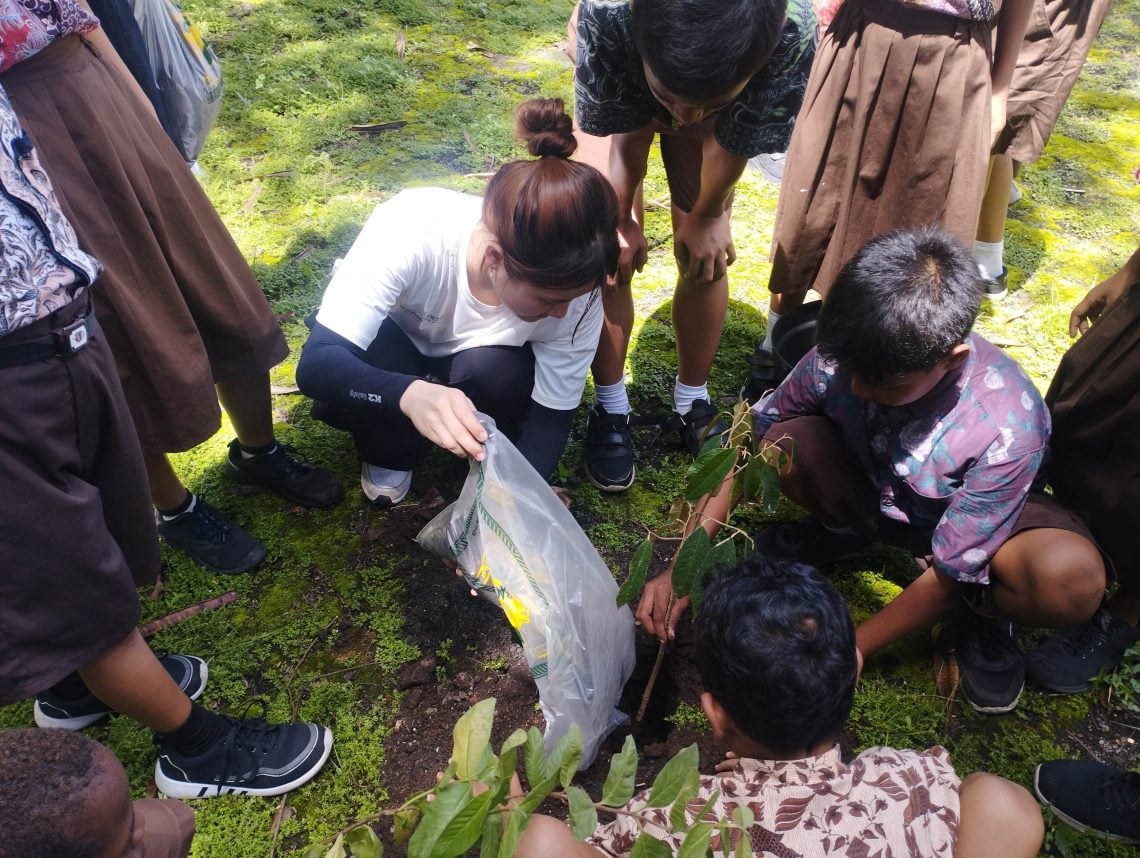 Peduli Lingkungan, YMCA Korea Selatan Ajak Pemuda di Malang Raya Tanam Pohon 5 Salah satu pemuda anggota YMCA Korea Selatan membantu siswa melaksanakan penanaman pohon.(foto: Yona)